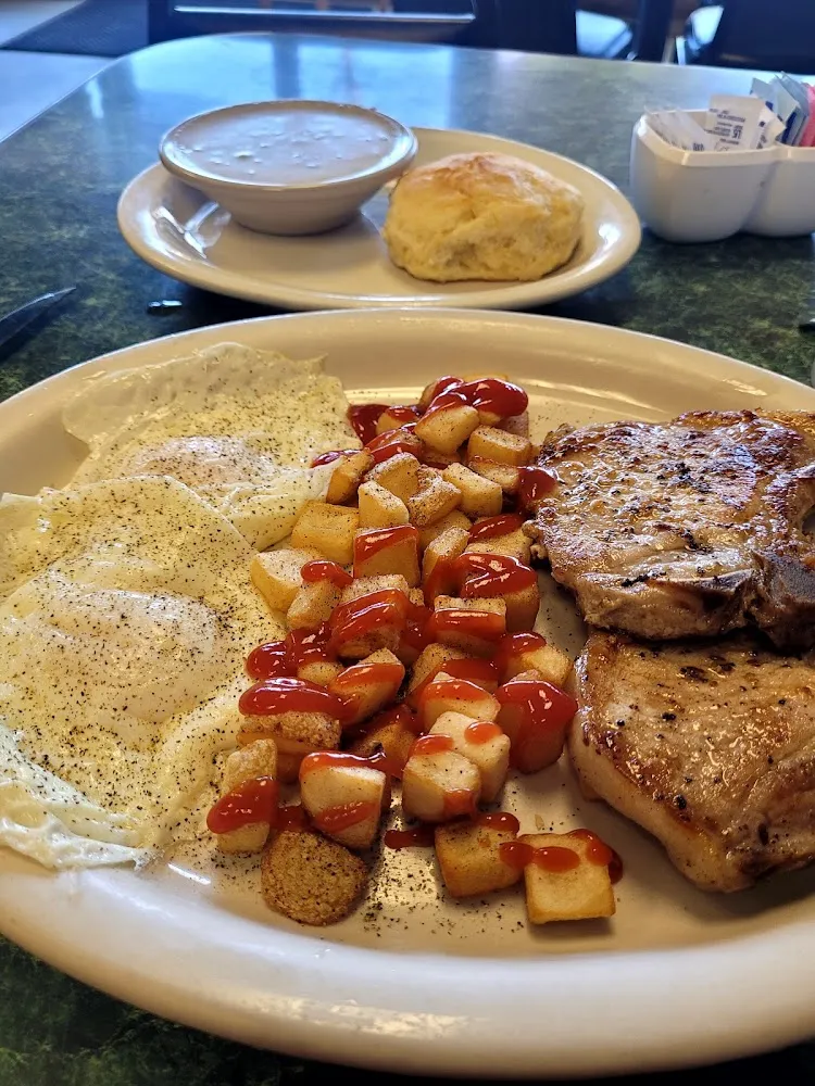 Pork Chop 1 Egg Half Order of Potatoes and Choice of Biscuit Toast or English Muffin